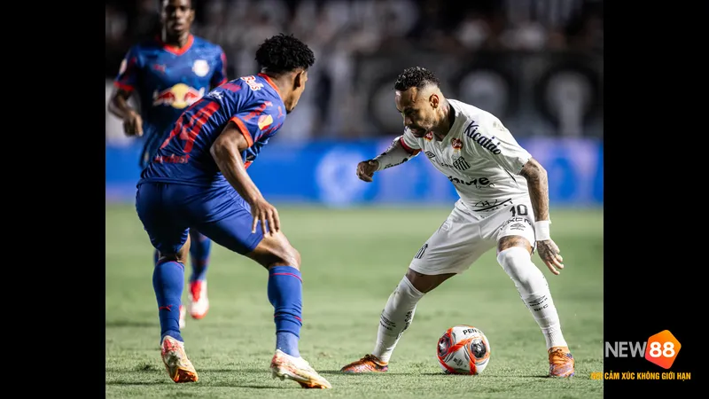 Cầu thủ Bragantino với b&oacute;ng trước cầu thủ Santos đang ph&ograve;ng ngự kỹ lưỡng